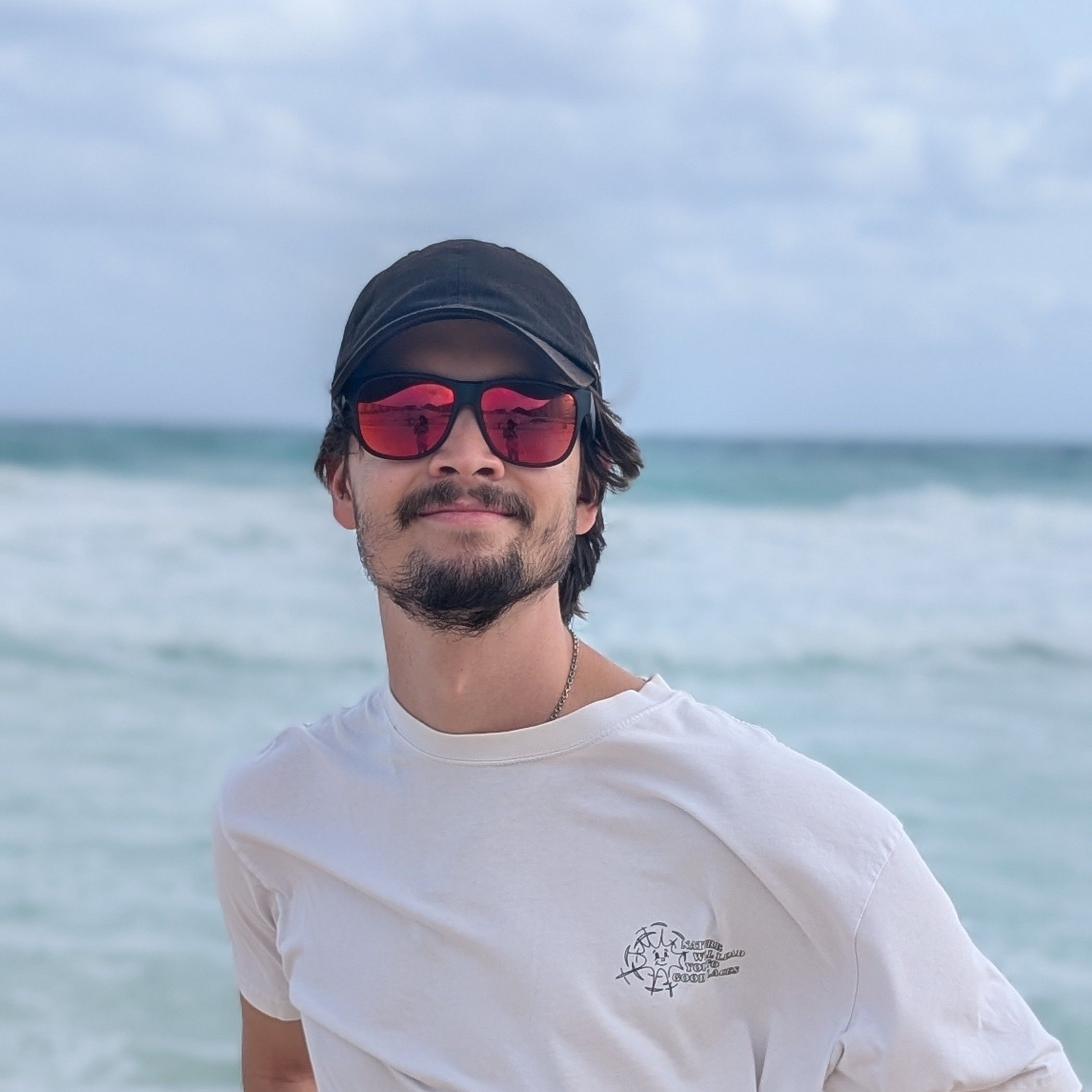 headshot of justin at the beach