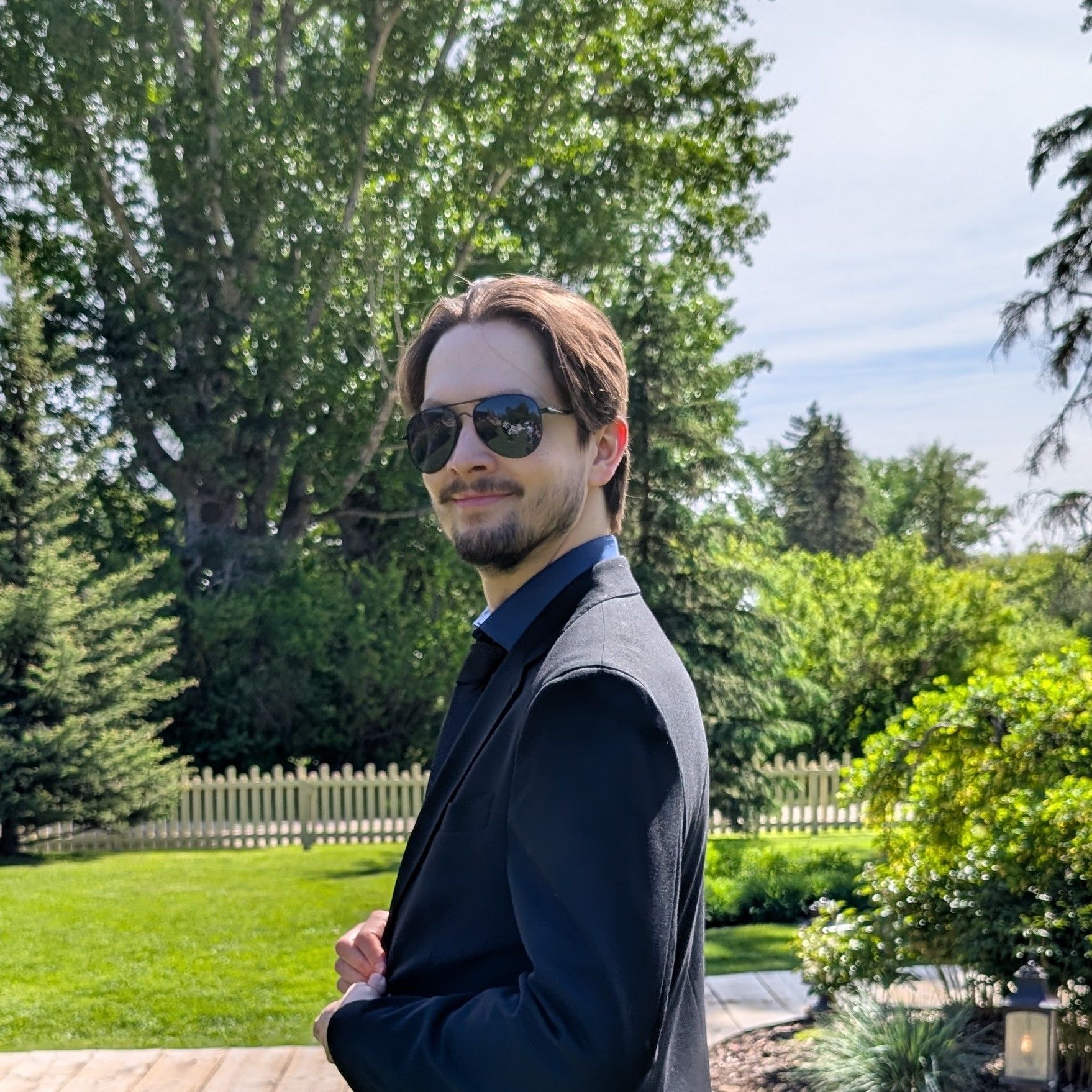 headshot of justin shaw in a park